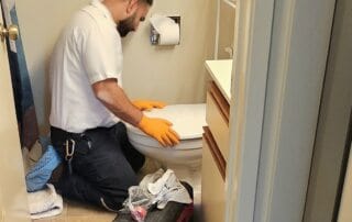 Plumber working on toilet in Burbank, CA